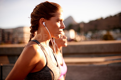 Buy stock photo Earphones, running and race with women in city for health podcast, workout and exercise playlist. Runner, wellness and music with people training for sports athlete, fitness  or marathon practice