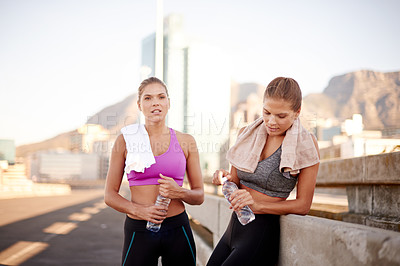 Buy stock photo Workout, city and women on road with water break for marathon training, cardio exercise and fitness challenge. Portrait, twin sisters and urban run for endurance, outdoor wellness and goal together