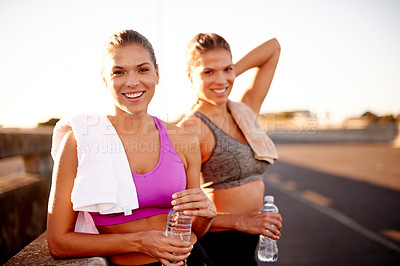 Buy stock photo Women, smile and portrait in city for fitness, wellness or bonding for relationship development. Twin sisters, happy or relax in urban Portugal on exercise break, rest or family support for self care
