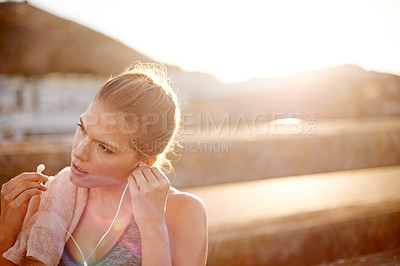 Buy stock photo Fitness, girl and earphones in city for music, exercise break and exhausted with space. Runner, resting or outdoor with technology for podcast, audio book or ready with training in Portugal.