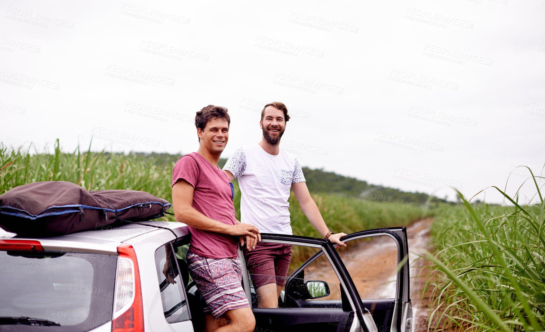 Buy stock photo Friends, travel and men in portrait by car for roadtrip break, holiday adventure and exploring nature on dirt road. Space, people and happy in countryside for weekend getaway, tourism and bonding