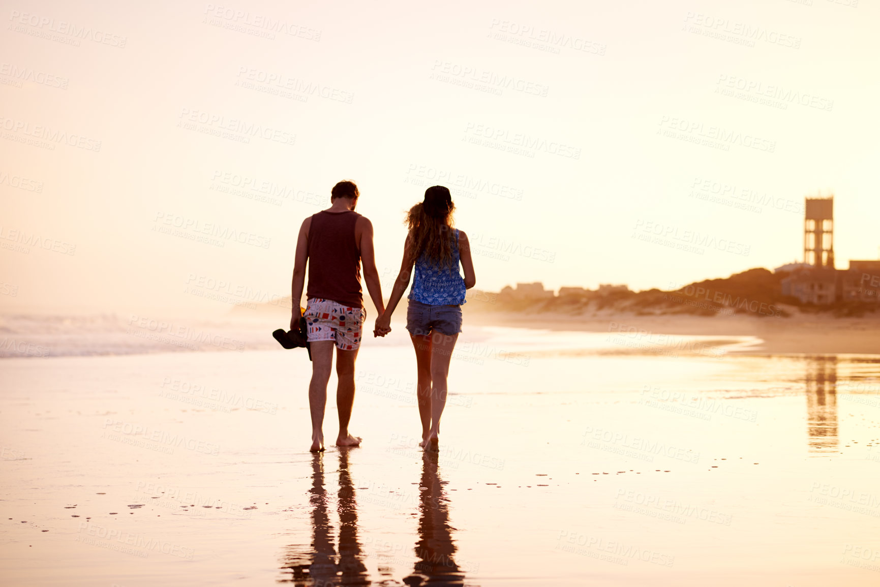 Buy stock photo Couple, holding hands and walking together at beach for holiday adventure, sunset date and bonding. Back space, people and romantic stroll on sand for sightseeing, explore nature and relationship fun