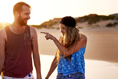 Buy stock photo Couple, pointing and happy together at beach for holiday adventure, travel vacation and bonding. Love, people and walking by seaside for sightseeing, explore nature and relationship fun with support