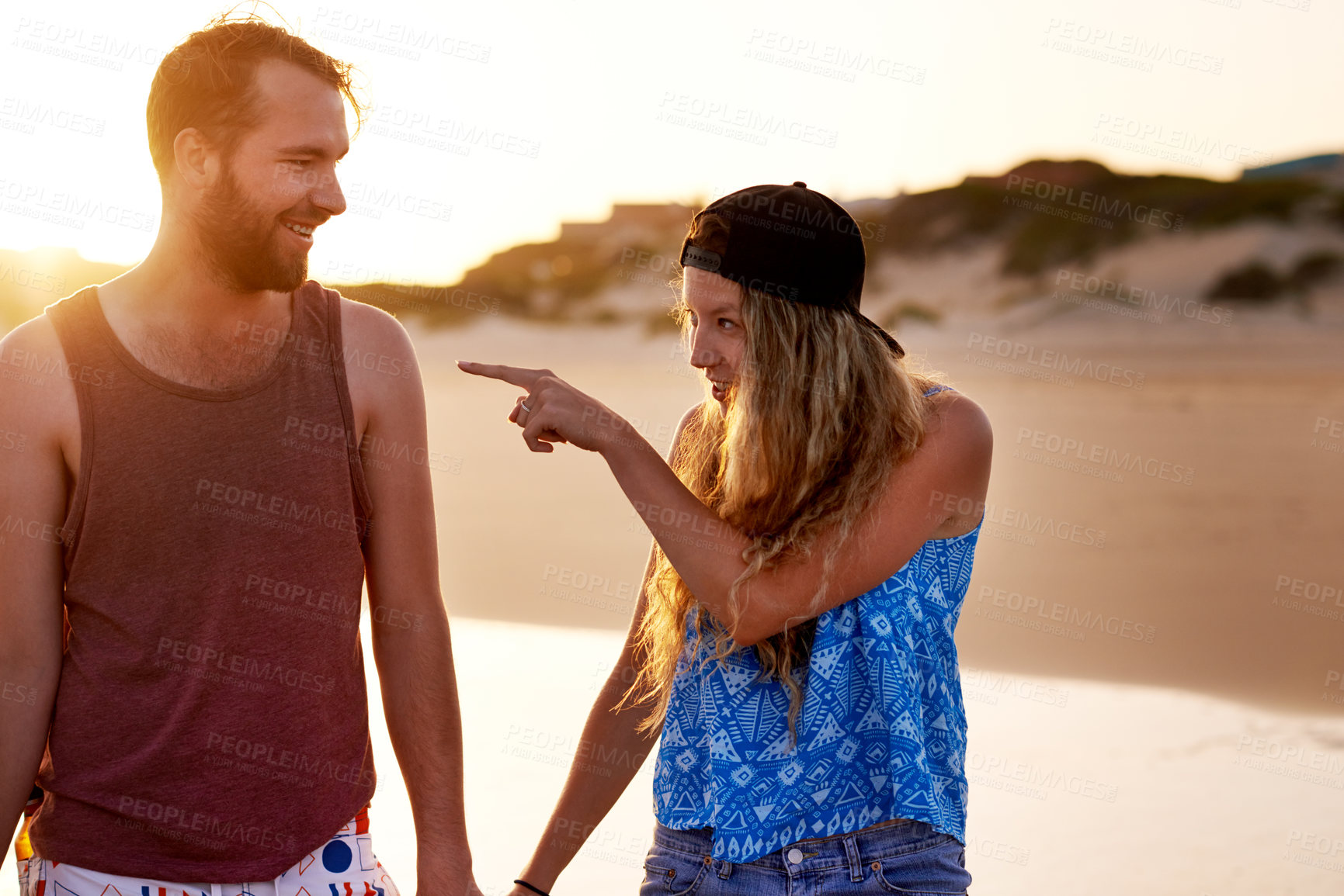 Buy stock photo Couple, pointing and happy together at beach for holiday adventure, travel vacation and bonding. Love, people and walking by seaside for sightseeing, explore nature and relationship fun with support