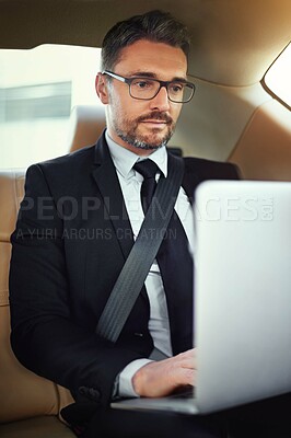 Buy stock photo Businessman, typing and laptop in car for travel with online project research, writing email and work commute. Male person, ceo and computer in motor for chauffeur service, reading report and admin