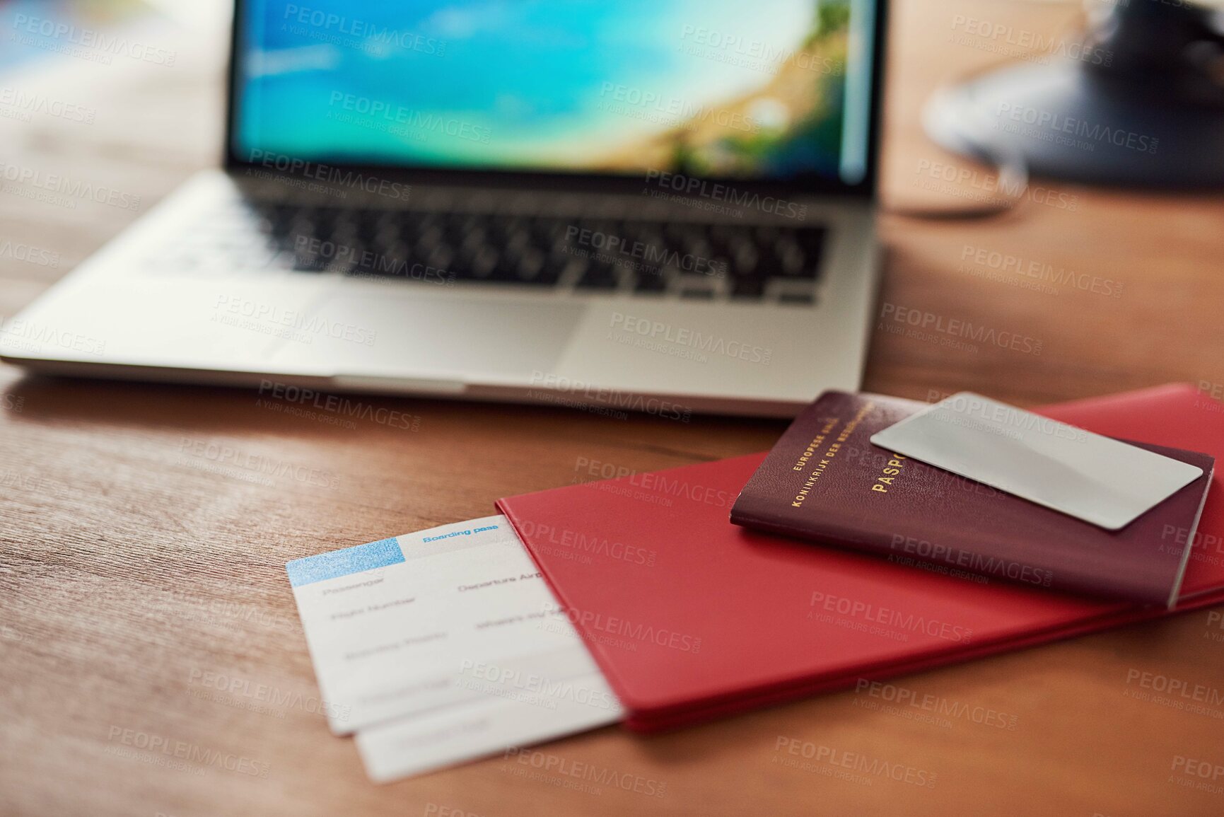 Buy stock photo Shot of travel documents and a laptop on a table