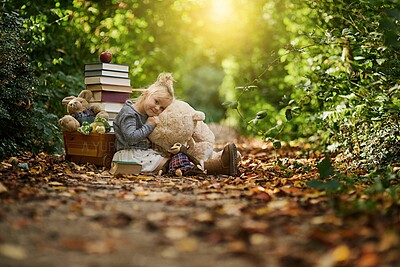 Buy stock photo Books, teddy bear and portrait of child in forest for learning, education and reading fairytale. Happy, lens flare and young girl with toys in nature, natural park and enchanted woods for adventure