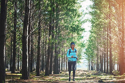 Buy stock photo Exercise, running and girl in woods with wellness, trees and challenge on morning workout. Nature, healthy fitness and woman in forest for outdoor marathon, endurance training and resilience in park