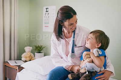 Buy stock photo Doctor, child and hug in hospital for support, healthcare checkup and happy for bravery. Pediatrician, young boy or teddy bear in practice for comfort, vaccine schedule or medical expertise with care