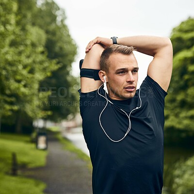 Buy stock photo Outdoor, stretching and man with fitness, flexible and energy for warm up, listening to music and training. Person in park, podcast or runner with exercise, healthy and workout with wellness or radio