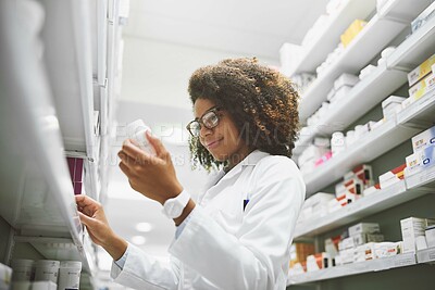 Buy stock photo Woman, wellness and pills with pharmacy check, medical career or healthcare service with zoom. Female pharmacist, workplace and package inspection for inventory, prescription stock in drug store