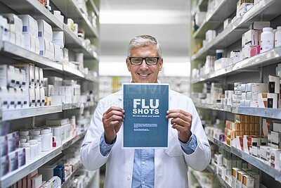 Buy stock photo Portrait of a mature male pharmacist holding up a sign indicating that you can get flu shots there