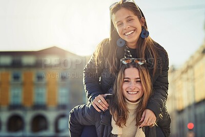 Buy stock photo Women, piggyback and outdoor portrait in city, bonding and travel to Berlin on weekend trip. People, together and games on vacation in urban town, laughing and love in sisterhood or relationship