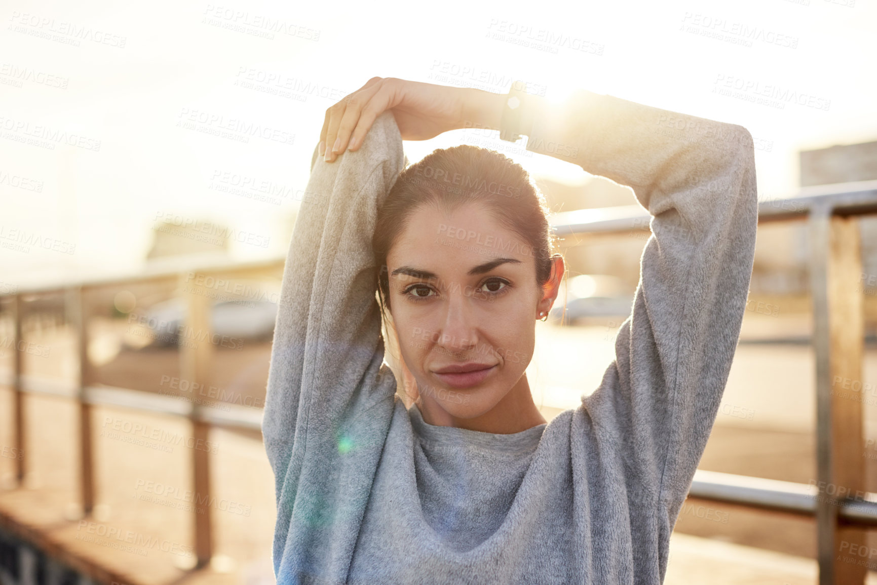 Buy stock photo Fitness, portrait and woman stretching in city for healthy body, wellness or prepare at sunset. Warm up arm, face and female runner outdoor for training, exercise or determination for sports marathon