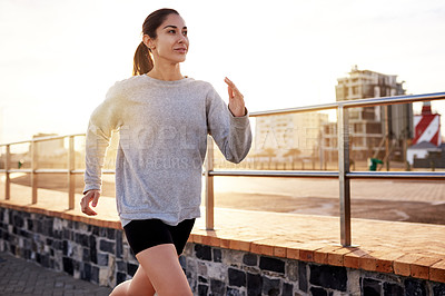 Buy stock photo Fitness, exercise and woman running in city for healthy body, wellness or jog to lose weight at sunset. Cardio, outdoor and athlete training, sports or endurance workout with energy for marathon race