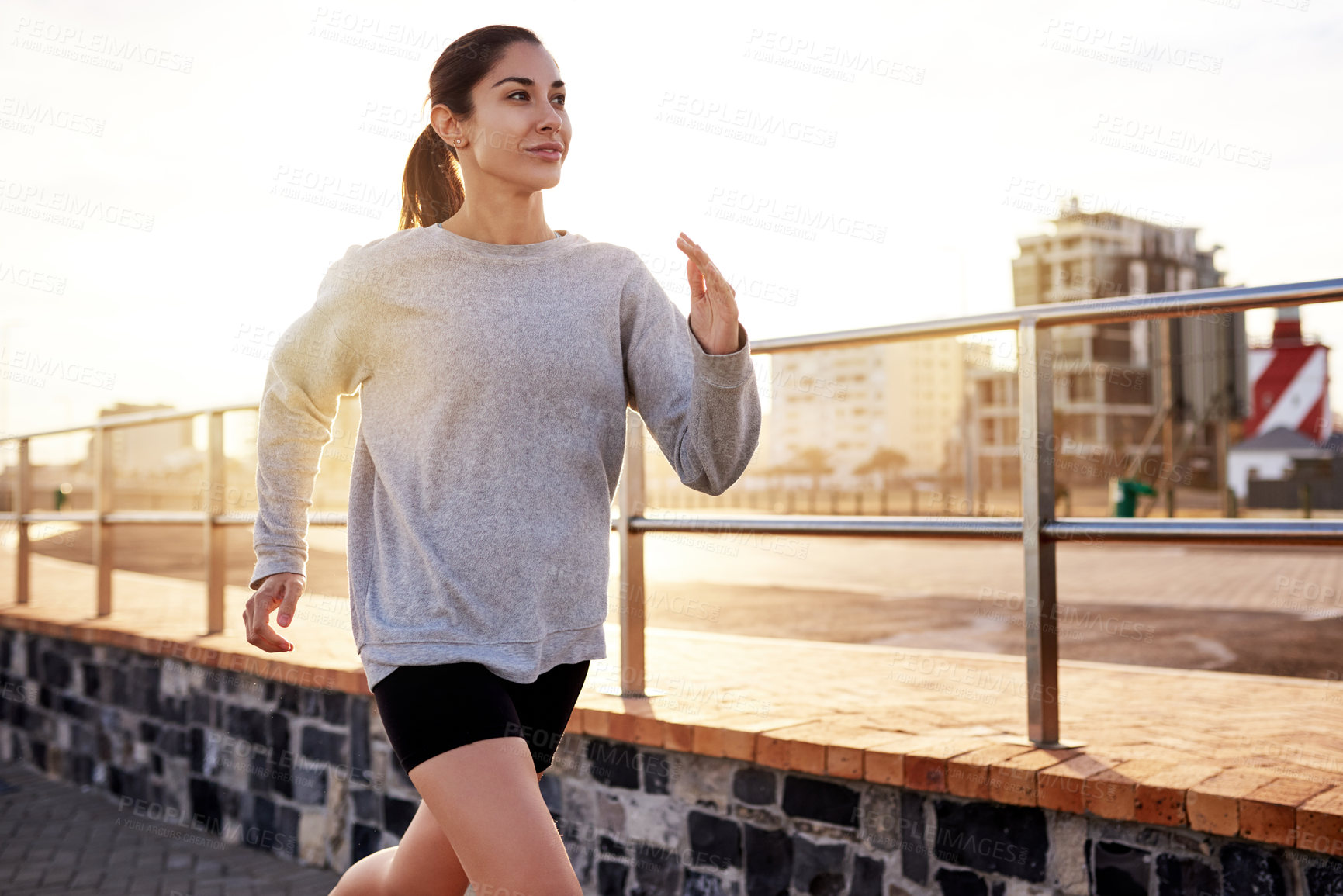 Buy stock photo Fitness, exercise and woman running in city for healthy body, wellness or jog to lose weight at sunset. Cardio, outdoor and athlete training, sports or endurance workout with energy for marathon race