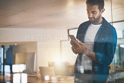 Buy stock photo Man, phone and texting at startup, night and overtime with update, reading and contact with app at company. Person, smartphone and check notification with smile, office or web chat at creative agency