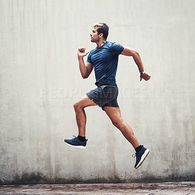 Buy stock photo Man, running and air jump with wall for wellness, training and exercise for healthy body. Male runner, fitness or sport with motion in workout, athlete in outdoor profile for jog with cardio