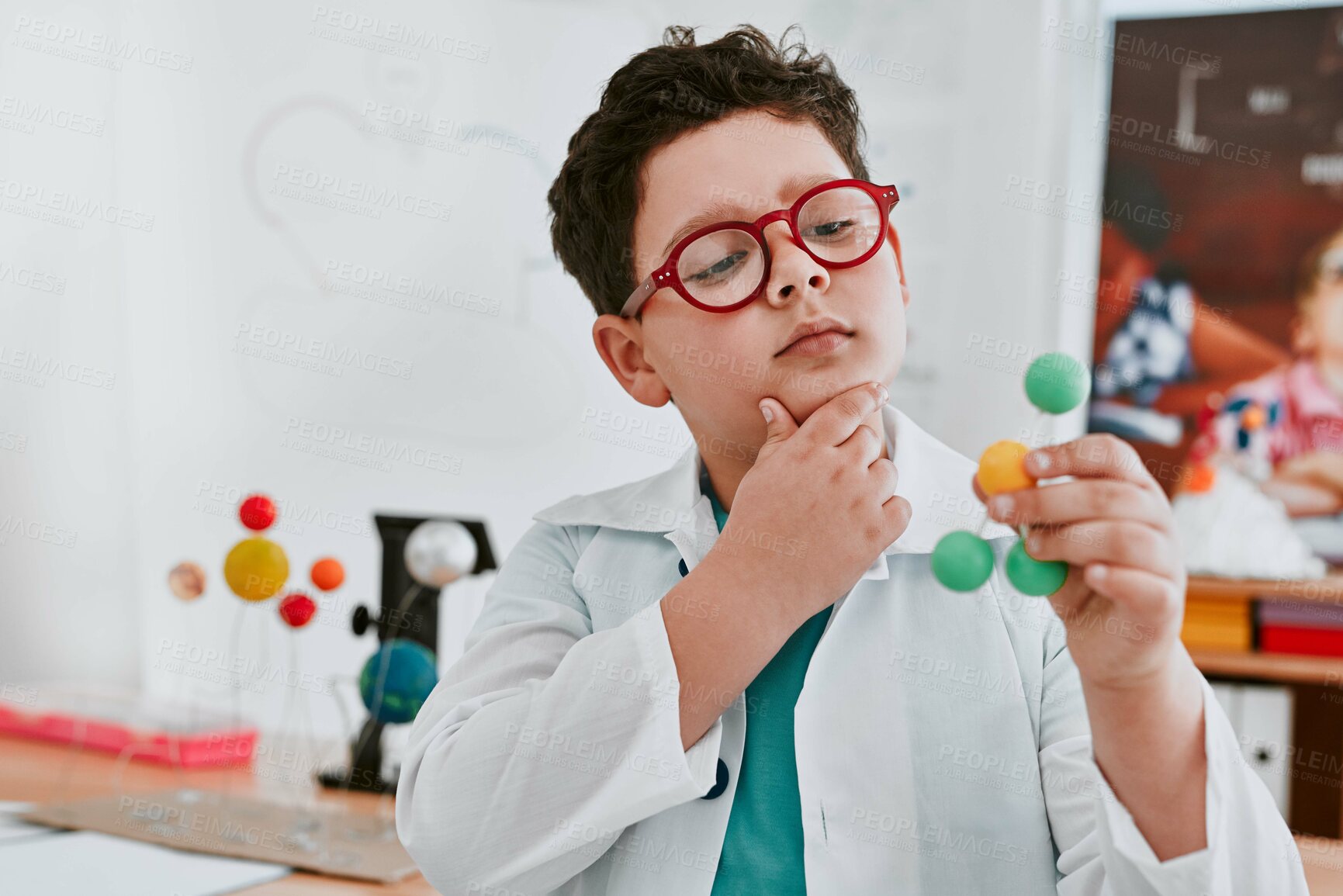 Buy stock photo Boy, lab coat and molecule model in classroom with thinking, glasses and learning for development. Child, particles and education for science with ideas for studying, growth and progress at academy