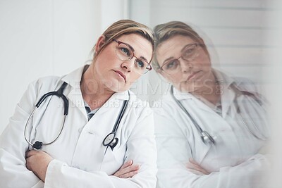 Buy stock photo Leaning, window and doctor with thinking, woman and depression with burnout in hospital. Person, professional and medical with reflection, decision and overworked with stress, doubt and specialist