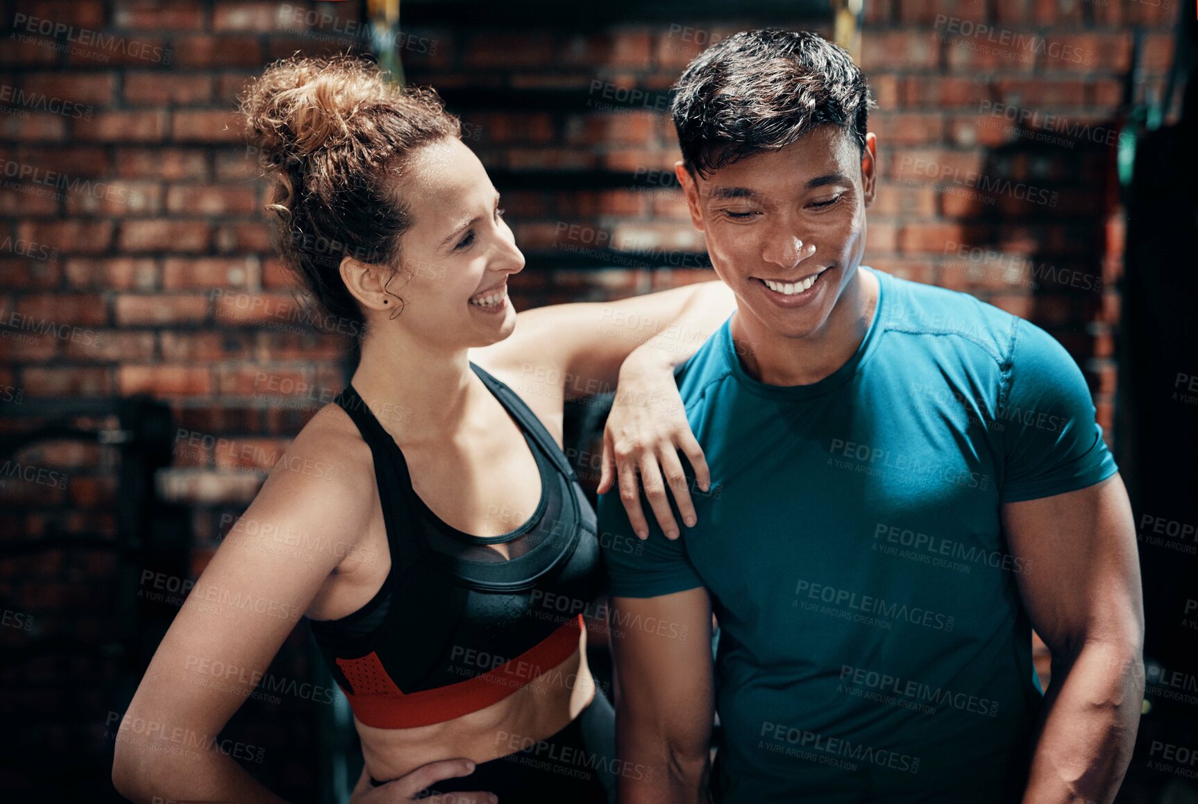 Buy stock photo Fitness, couple and happy for workout at gym with conversation, talking and exercise for healthy body. Personal trainer, partner and people with training break, relax and laughing in sports center