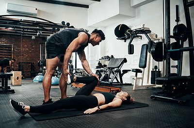 Buy stock photo Personal trainer, woman and help in gym for fitness, stretching and warm up for exercise. Man, customer and coaching in wellness club for physical activity, health and support in training on floor