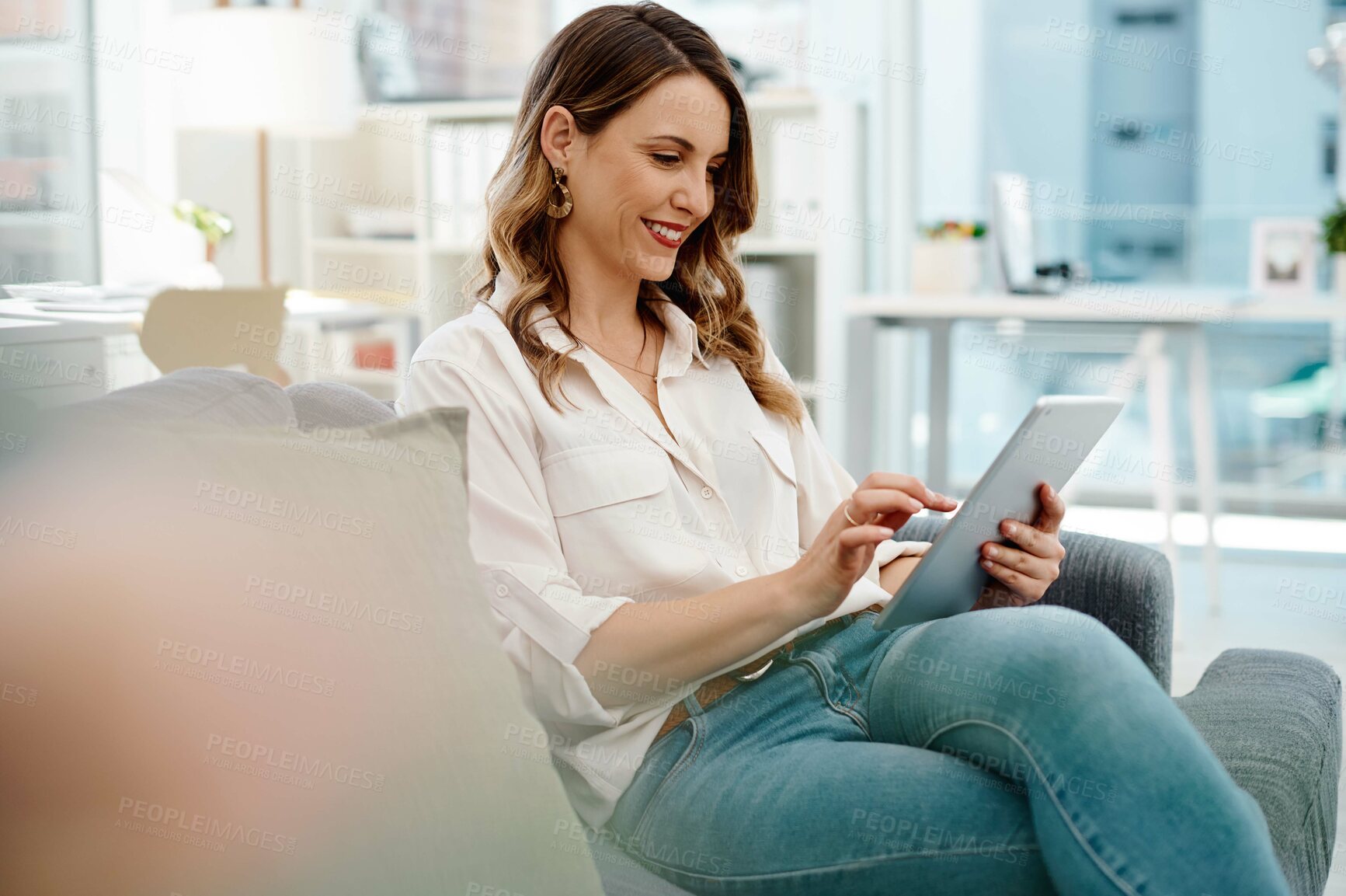 Buy stock photo Happy, woman and tablet on sofa in office for legal research, information and online news for case study. Female attorney, couch and digital for reading email, website and schedule of law firm goal

