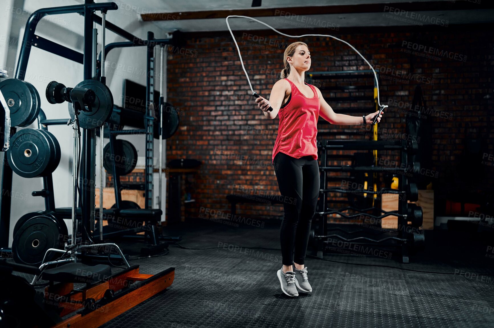 Buy stock photo Woman, jump rope and fitness in gym with workout for muscle development with training, health and wellness. Person, balance and challenge with cardio for transformation, change and exercise at club