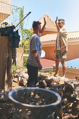 Buy stock photo Cleaning, support and high five with men in outdoor for sunshine, linen and success. Maintenance, laundry and teamwork with people in backyard of home for housekeeping and washing clothes together