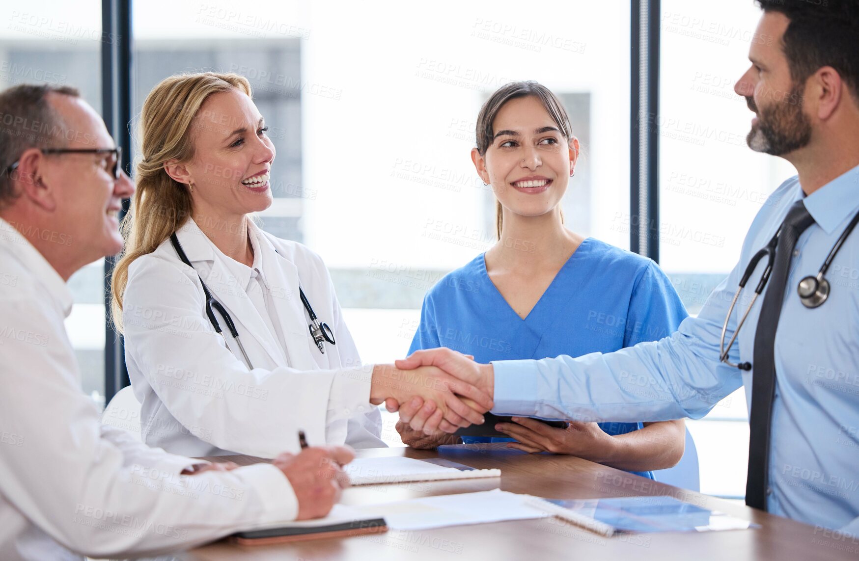 Buy stock photo Business, meeting and doctors shaking hands in office for agreement, investment or healthcare deal. Health insurance, men and women with medical consultant for hospital funding, handshake or support