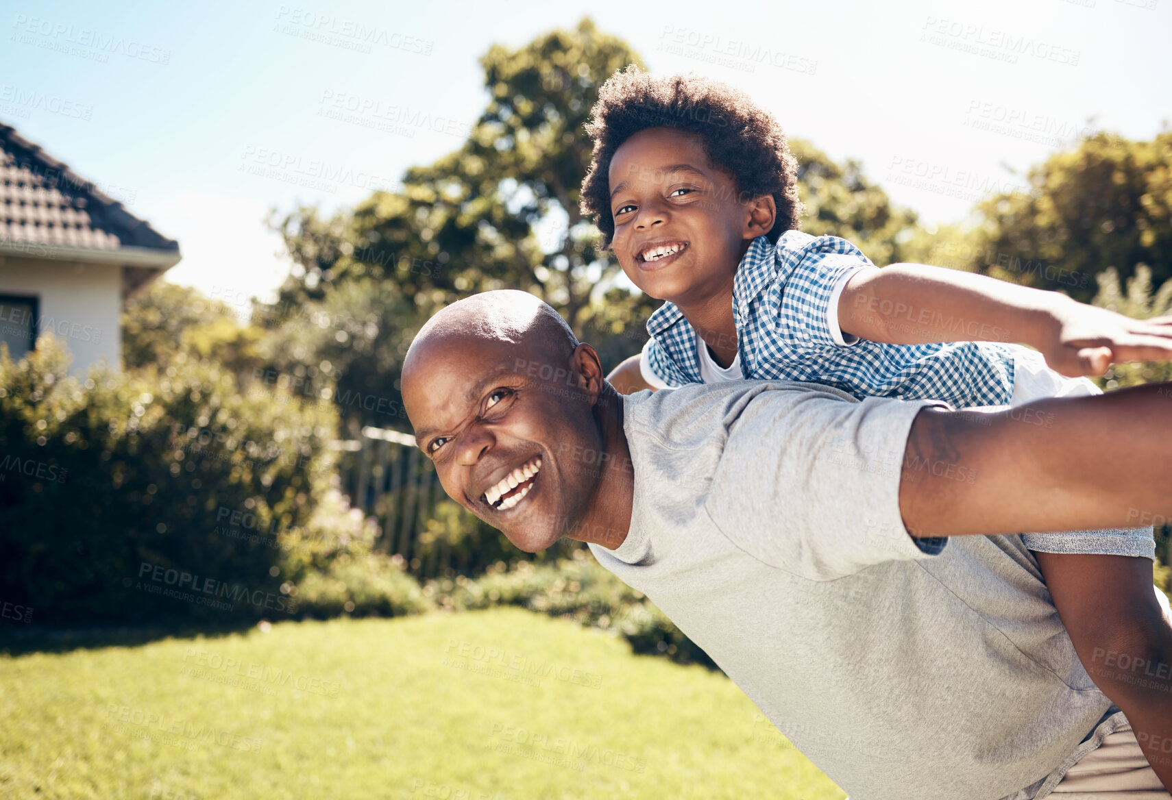 Buy stock photo Piggy back, backyard and dad with child for playing, fun and bonding together on weekend. Family, happy and African father with son on grass for playful relationship, childhood and relax outdoors