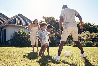 Buy stock photo Happy, football and parents playing with children in backyard for bonding, adventure or family time. Fun, outdoor and kids learning soccer with mom and dad in garden for sports development on grass.