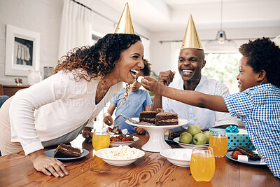 Buy stock photo Cake, eating and family at birthday in home for party, event or gathering together for bonding. Love, connection and child feeding mom dessert for celebration with hats and gifts for tradition.