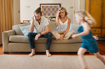 Buy stock photo ADHD, motion blur and stress of parents with daughter running in living room of home for hyperactivity. Anxiety, autism or energy with unhappy mom and dad on sofa in apartment for break or rest