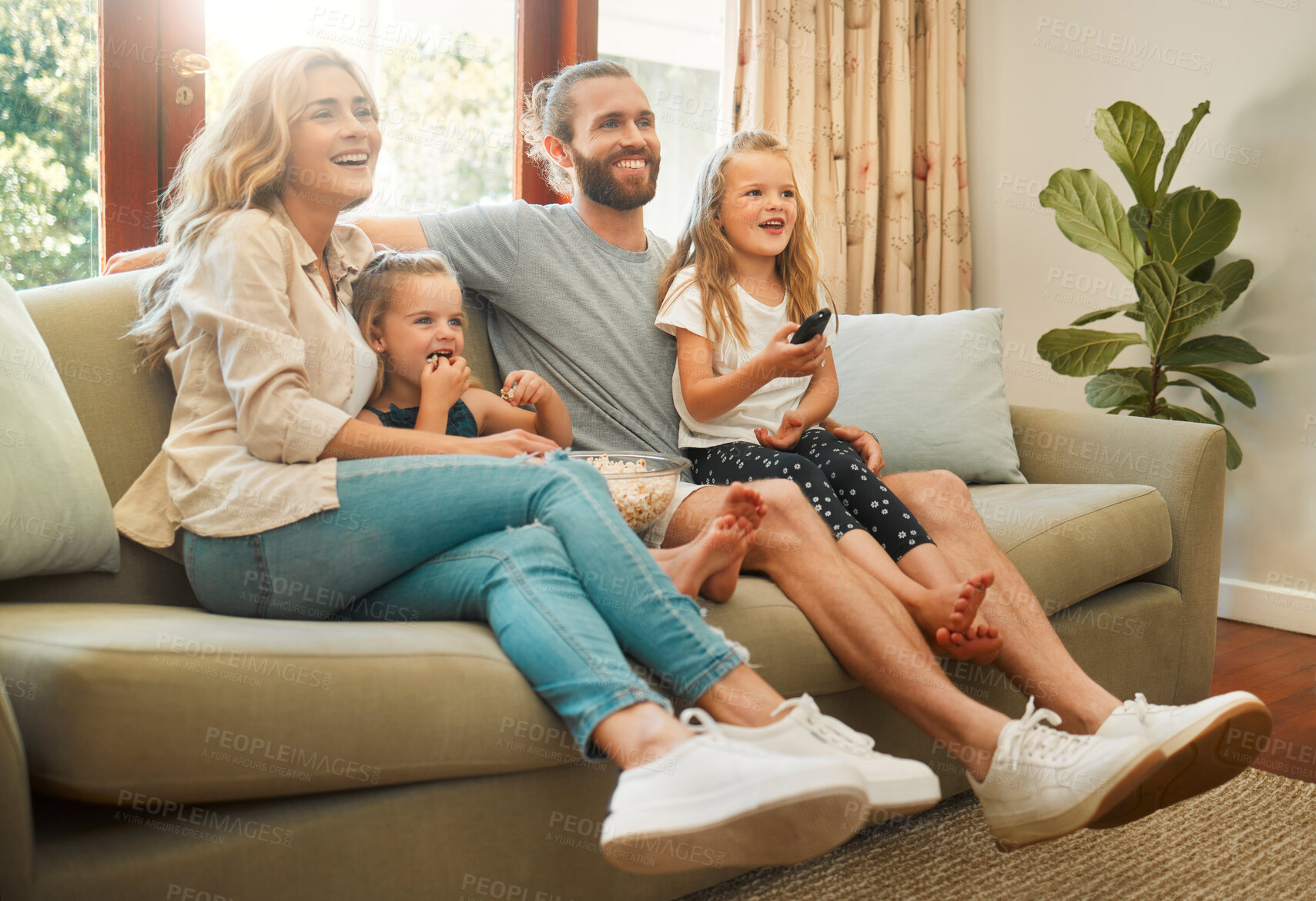 Buy stock photo Relax, sofa and family in home watching tv, movie or show together for entertainment. Happy, love and girl children streaming film with parents in living room for bonding on weekend in house