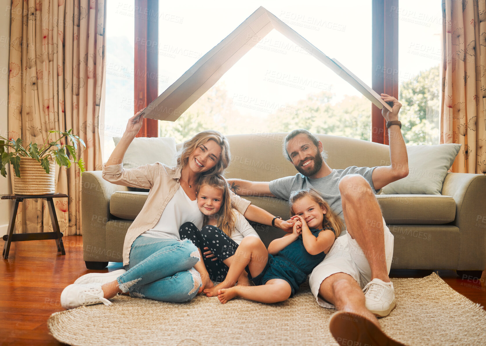 Buy stock photo Cardboard, cover and portrait of family on floor of living room in home together for insurance. Loan, mortgage or new home with mother, father and children in apartment for future, safety or security