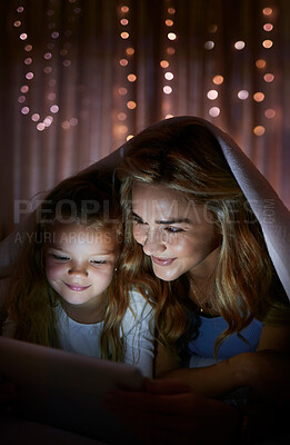 Buy stock photo Blanket, cover and tablet with family in bedroom of home at night for excitement or storytelling. Reading, smile or video streaming with mother and daughter in apartment for bonding at bedtime