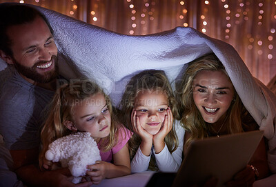 Buy stock photo Blanket, tablet and night with happy family in bedroom tent of home for excitement or storytelling. Reading, streaming or video with mom, dad and daughter kids in apartment for bonding at bedtime
