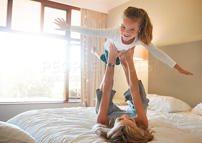 Buy stock photo Mother, child and airplane game on bed for bonding, trust development and support in home. Kid portrait, mom and playing in bedroom with flying fantasy, love and happy for relationship with balance