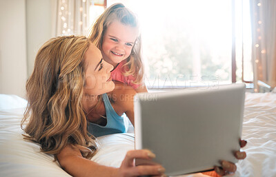 Buy stock photo Bedroom, education or tablet with mother and daughter in home together for gaming, learning or streaming. App, development or social media with woman parent and girl child in apartment for bonding