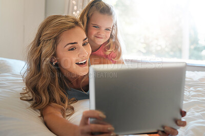 Buy stock photo Bedroom, surprise or tablet with mother and daughter in home together for gaming, learning or streaming. App, social media or wow reaction with woman parent and girl child in apartment for bonding