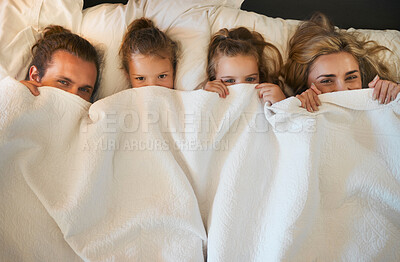 Buy stock photo Parents, children and hide in blanket for relax, lazy morning and comfort in bed. Above, happy family and portrait in home with cover, playful and bonding on weekend with rest, care or childhood game