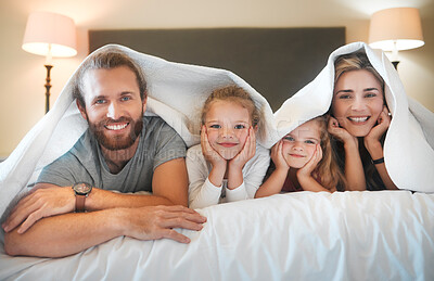 Buy stock photo Happy family, portrait and blanket on bed for relax, comfort and security in home. Parents, children and smile in bedding for protection, insurance cover and bonding on weekend with love in bedroom