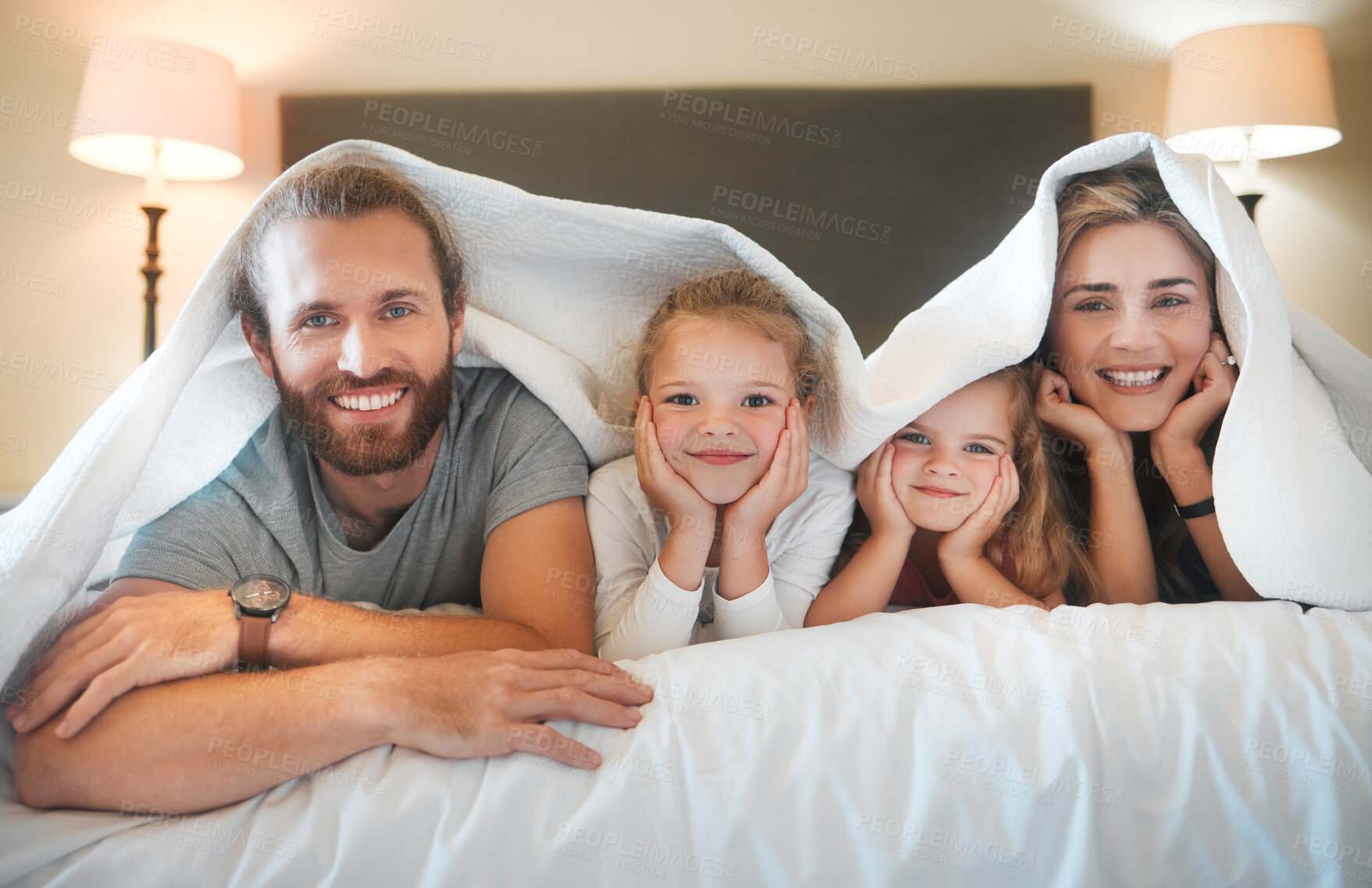Buy stock photo Happy family, portrait and blanket on bed for relax, comfort and security in home. Parents, children and smile in bedding for protection, insurance cover and bonding on weekend with love in bedroom