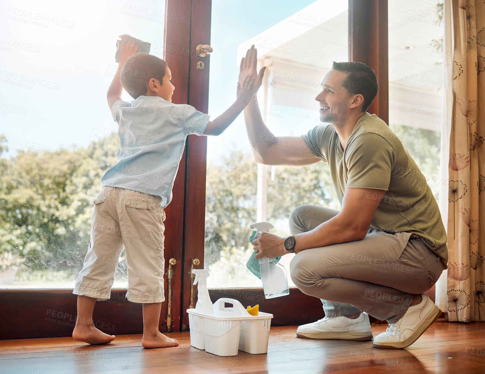 Buy stock photo Cleaning, door and high five of father with son in living room of home together for weekend chores. Motivation, success or teamwork of man parent and boy child in apartment with rag and spray bottle