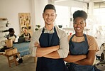 Fashion, design and style with two diverse and professional team members standing arms crossed and working in a creative workshop. Serious and confident textile workers in a small business startup