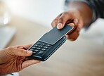 Customer shopping with credit card money and paying using digital nfc technology while buying in a store. Closeup of two hands making a finance, online banking or consumerism transaction from above