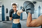 Boxing female boxer at gym with sports personal trainer practicing or training together for fight or match. Fitness and wellness coach teaching fit active athlete or client fighting exercise workout