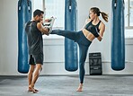 Kick boxing, exercise and healthy woman living an active health, motivation and wellness lifestyle. Athletic girl, fitness and sports athlete doing a workout or fight training in the gym