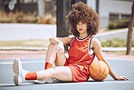 Confident female basketball coach with ball outside. Women's fitness motivation, workout, sports training and exercise wellness. Strong, powerful pro athlete posing for portrait on netball court.